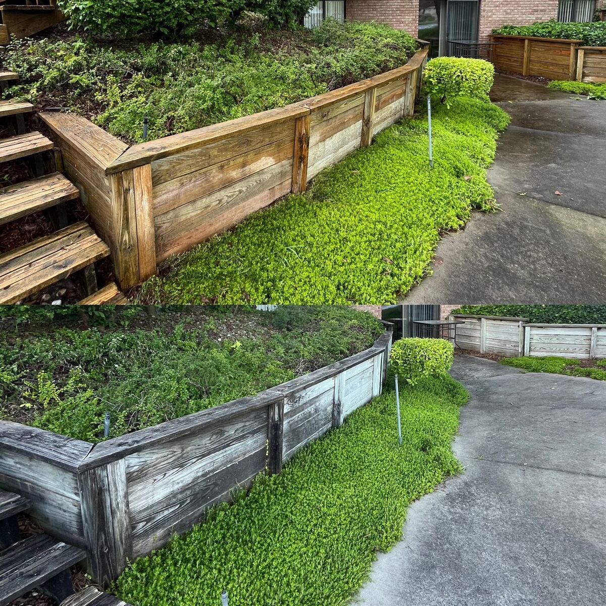 Weathered wooden retaining wall by a driveway before and after washing — gray grime stripped to fresh wood.